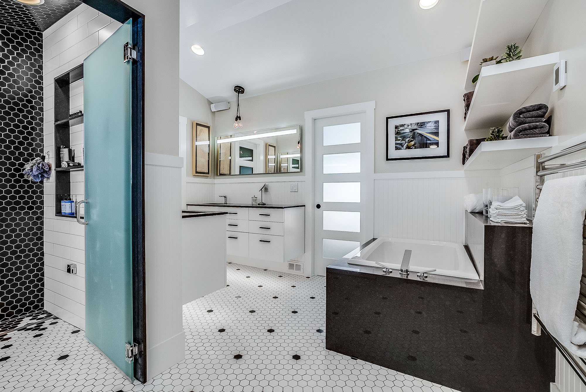 Seventh slide - Black and white master bathroom with tub, vanity and shower room